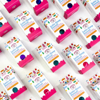 Multiple boxes of Satin Sleep Bonnets on a white background