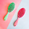 Green and pink hairbrushes on a pink and gray gradient background