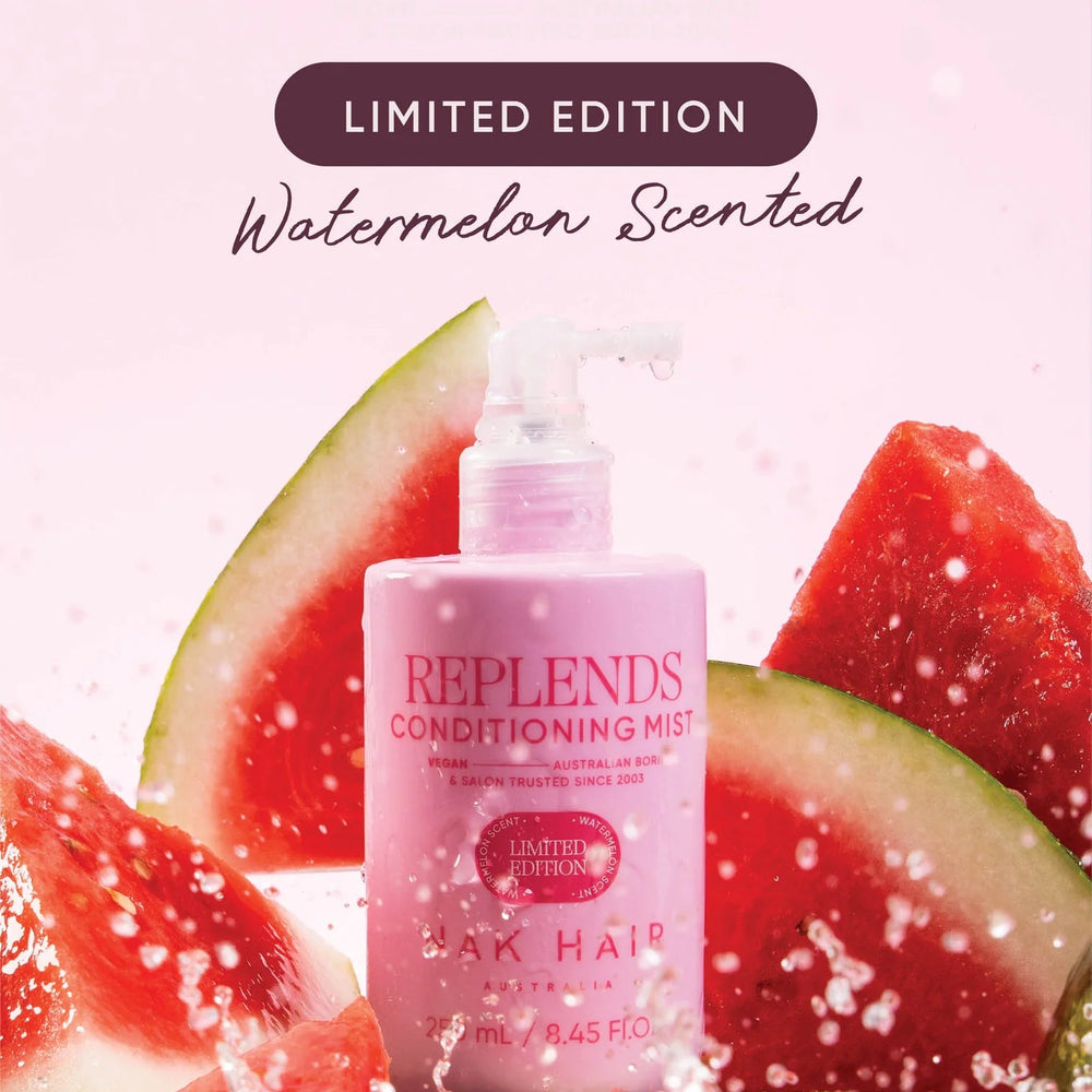 Pink bottle of Nak Hair Replends Conditioning Mist with watermelon slices on a pink background