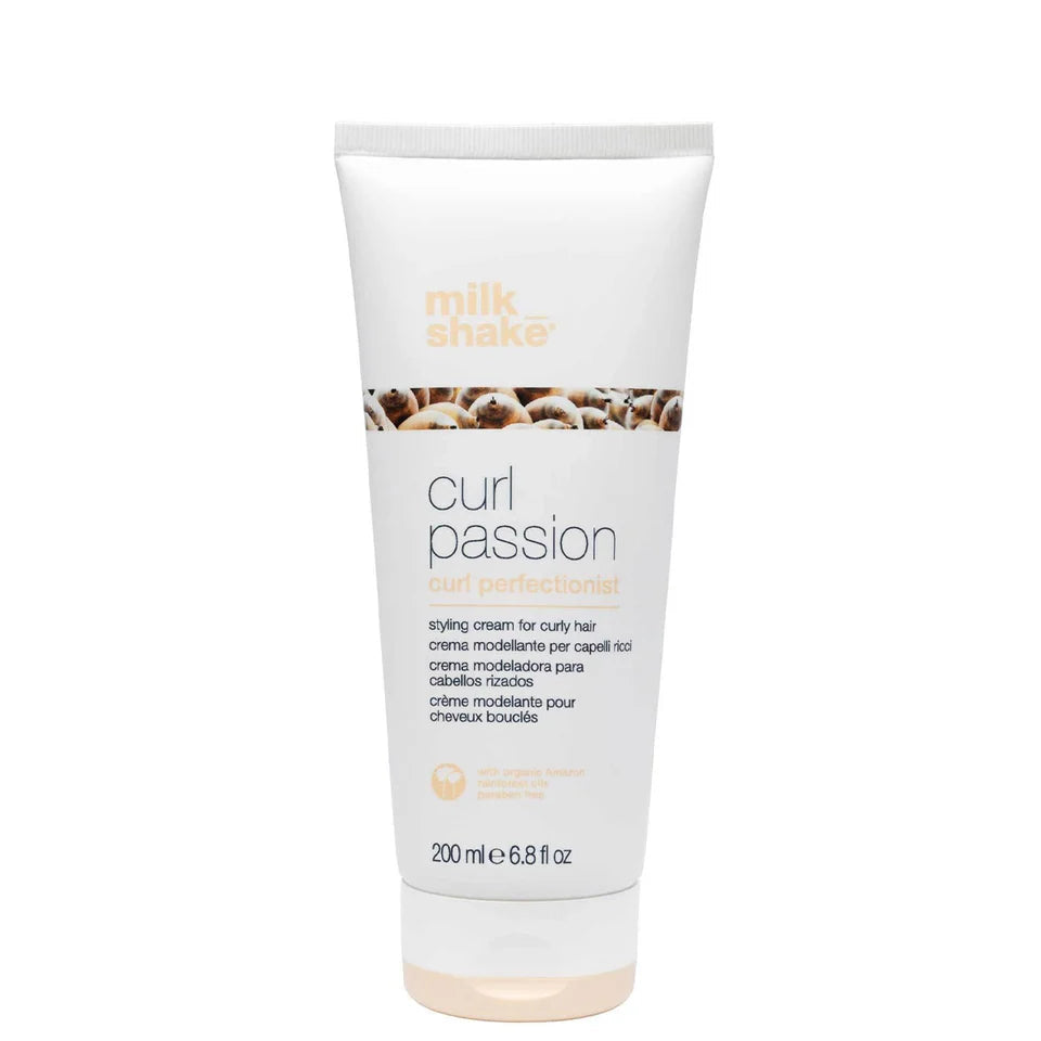 A white squeeze tube of Milk Shake Curl Passion Curl Perfectionist styling cream for curly hair, shown on a white background with a beige 'in salons now' badge in the top left corner.