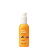 Orange bottle of 'milk shake moisture & more' hair product on a white background